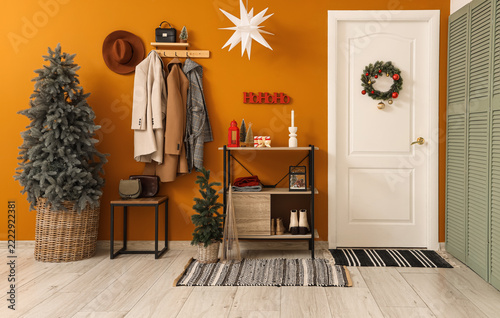 Christmas home interior, festive entryway with holiday decorations and winter...