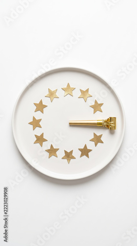 White Ceramic Plate with Golden Stars Clock Concept on White Background