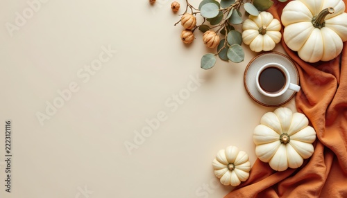 Minimalist flat lay of natural autumn elements: white pumpkins, dried eucalyptus leaves, linen fabric