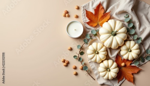 Minimalist flat lay of natural autumn elements: white pumpkins, dried eucalyptus leaves, linen fabric