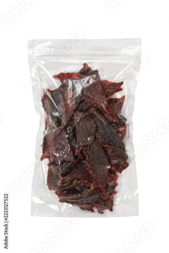 Fotografie Delicious dark brown beef jerky slices are neatly packed inside a clear plastic