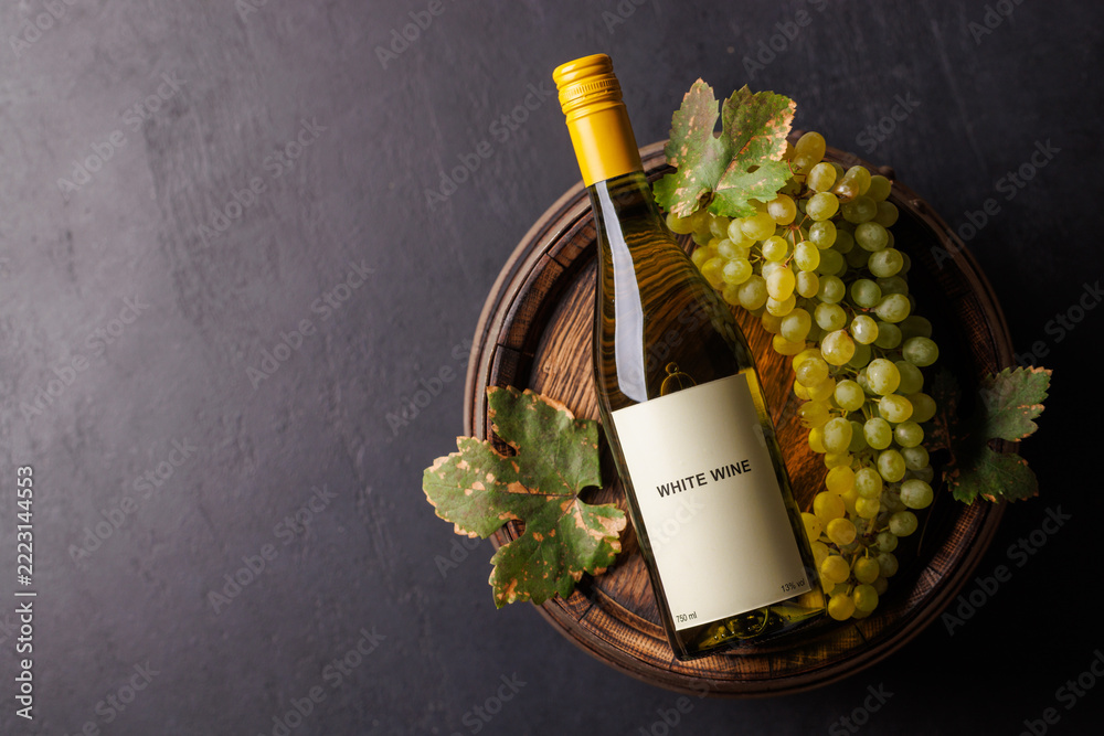 Fototapeta premium Vineyard harvest composition with bottled white wine