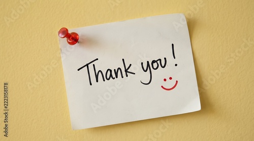 Handwritten 'Thank You!' note on a yellow sticky paper, a cheerful appreciation message pinned to a warm wall, a simple gratitude expression for business or personal use