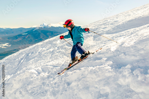 Active kid boy riding downhill,learn skiing in mountains alpine winter resort.little child enjoy extreme sport activities recreation,family luxury vacation