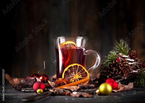 red mulled wine with cute christmas decoration on wooden board