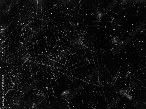 Old scratched film texture overlay with dust and hair particles for vintage photo effects and retro aesthetic design