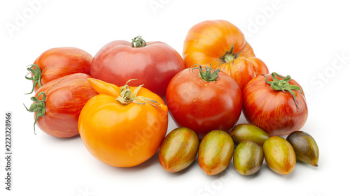 Fotografie Assortment of various colorful heirloom tomatoes isolated on white background