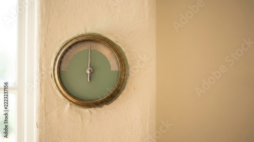 Vintage Analog Wall Gauge with Needle on Neutral Wall