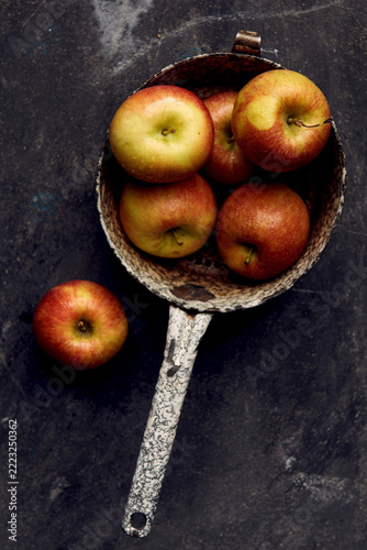 Braeburn apples in enamel colander with moisture droplets