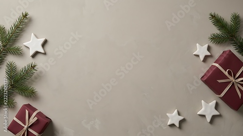 Festive christmas background with gift boxes and pine tree branches on a neutral grey surface flat lay evergreen celebration seasonal decoration greeting copy space