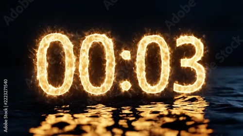 Glowing fire numbers 00:07 reflecting on dark water surface.