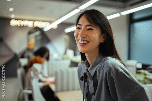 Smiling asian businesswoman enjoying a happy work environment