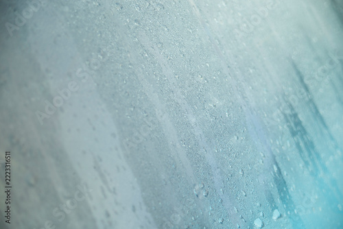Diagonal macro shot of dense water droplets and condensation on a glass surface.
A high-quality