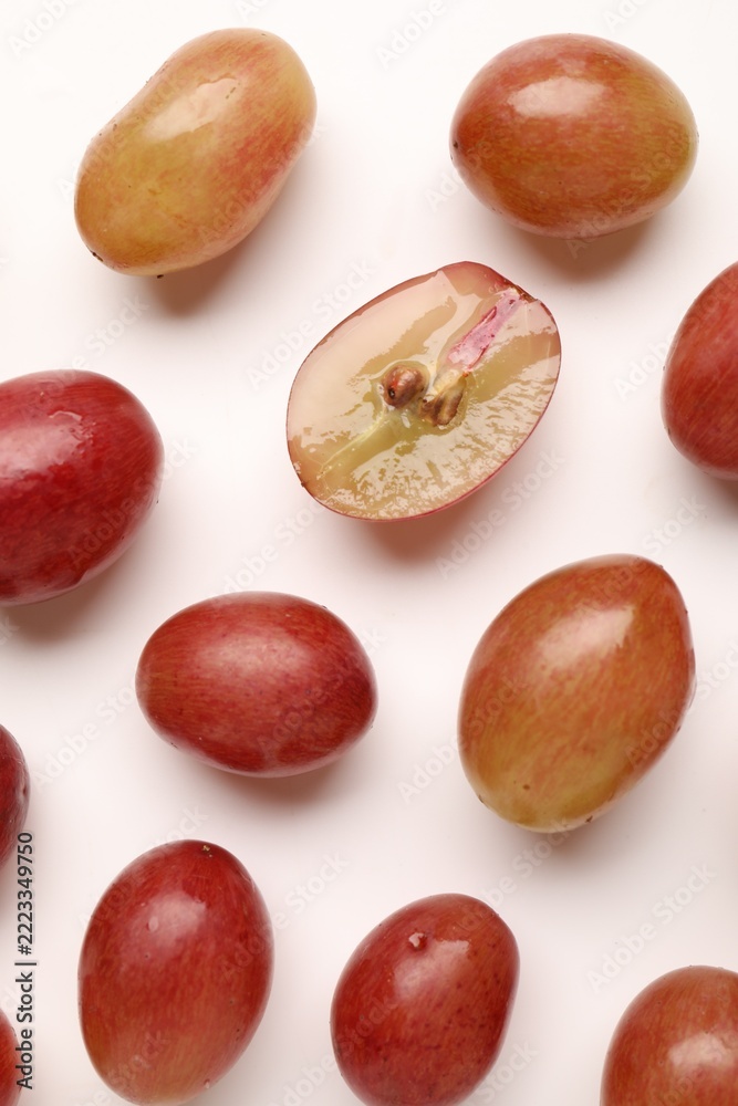 Fototapeta premium Fresh ripe grapes on white background, flat lay