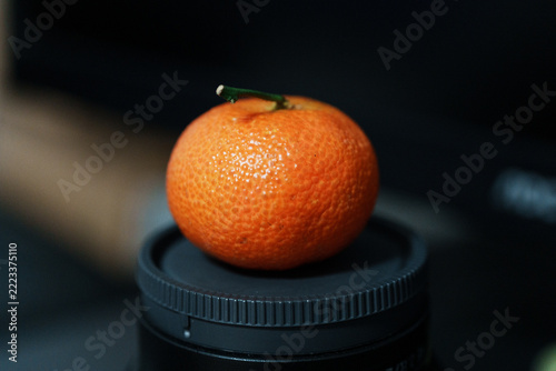 Close-up of Fresh Mandarin Orange on Camera Lens Cap