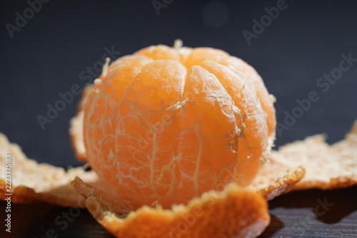 Close Up of Peeled Juicy Mandarin Orange on Dark Background