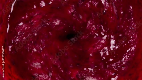 Blender with Berries and Sugar. Blender creates a berry funnel with sugar and a spray of mousse flying in the screen