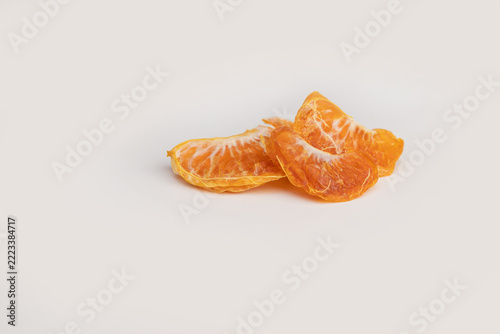  freeze dried mandarin segments isolated on a clean white background with large empty copy space. dehydrated citrus fruit snack showing natural orange color and texture, healthy nutrition 