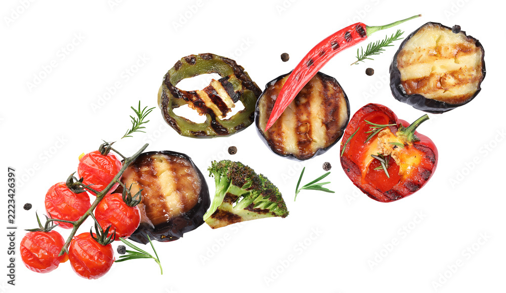 Obraz premium Grilled vegetables, fresh rosemary and peppercorns flying in air against transparent background