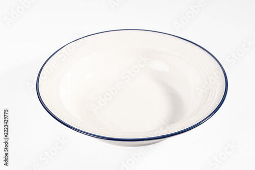 Wall Mural Empty white ceramic bowl with thin blue rim isolated on white background for foo