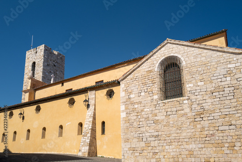 Historic cathedral bell tower and ochre facade in Antibes, French Riviera