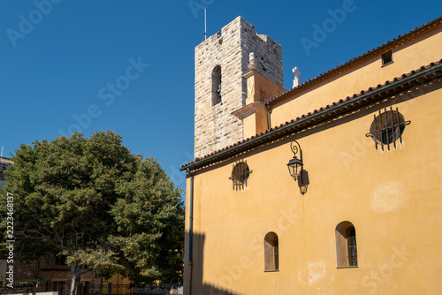 Historic church bell tower and ochre facade in Antibes, French Riviera