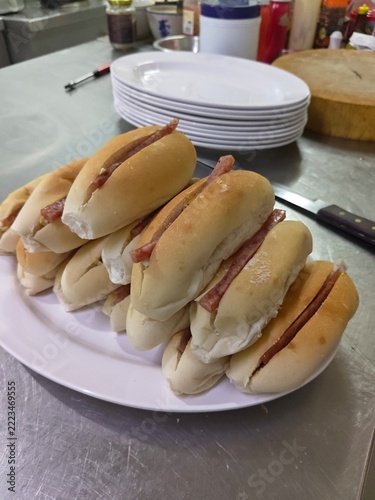 Pile of Sausage Sandwiches: A platter overflowing with freshly prepared sausage sandwiches, showcasing a tempting spread of simple yet delicious comfort food.
