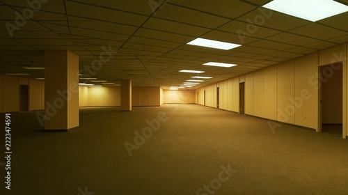 Vast, Empty Office Space with Fluorescent Lighting and Beige Walls Creating an Unsettling Atmosphere