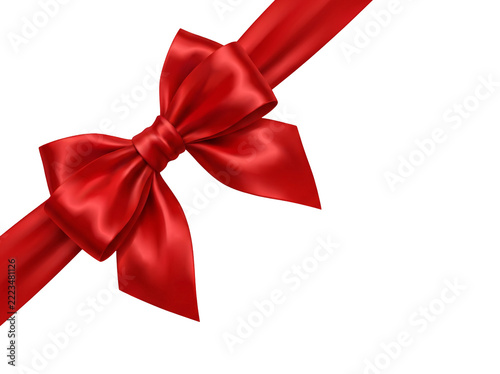 Fotografie Elegant diagonal red satin ribbon bow for gift corner decoration isolated on whi