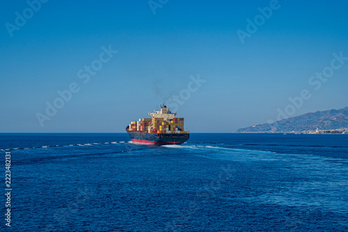 A cargo ship crosses the Strait of Messina (Italy)