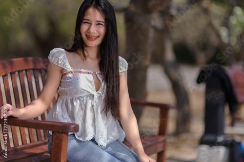 Young Woman Smiling on a Bench in Koh Si Chang, Chonburi Province