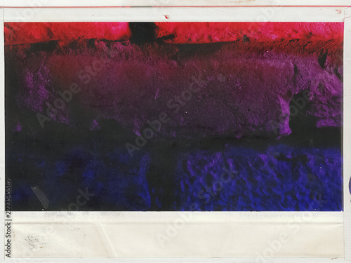 Abstract vintage textured print with red and purple grunge landscape effect on scanned paper border