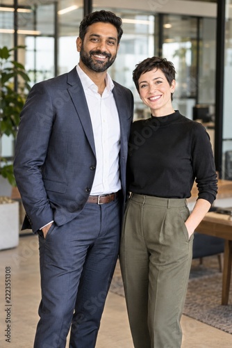Cheerful multiethnic business colleagues posing together in a modern office