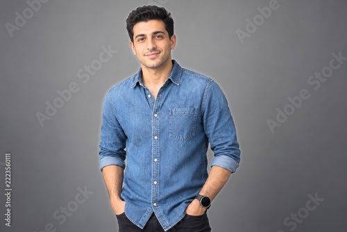 Young professional man in a denim shirt wearing a plain smartwatch