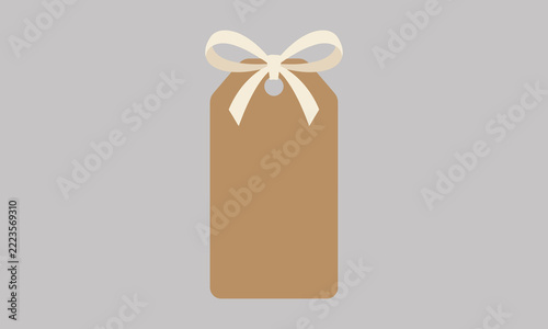 Brown gift tag with cream ribbon bow isolated on grey background for