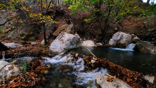 Scenic Woodland Creek with Multiple Cascades in Autumn. Tiered Waterfalls Flowing Through an Autumn Forest Stream. Small Cascading Waterfalls in a Colorful Fall Woodland.