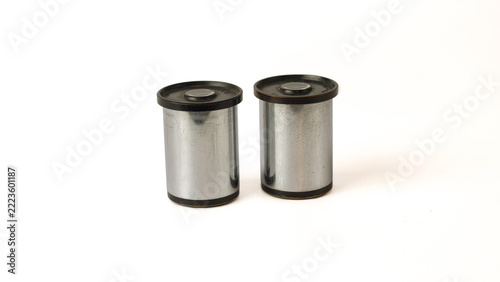 Fotografie Pair of microscope eyepieces with silver metal barrels, black housings and knurled top rings, isolated on a white background