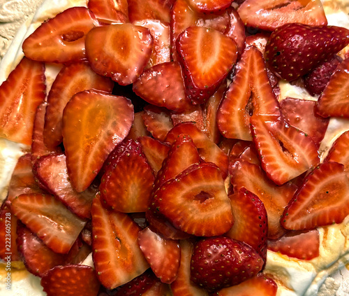 Sweet juicy honey glazed strawberries on a Pavlova dessert