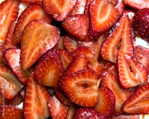 Sweet juicy honey glazed strawberries on a Pavlova dessert