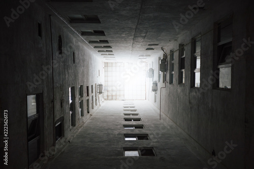 Obraz na plátně Upward view through narrow concrete lightwell of urban residential courtyard reveals repetitive windows, dramatic architectural geometry and limited daylight in enclosed building space