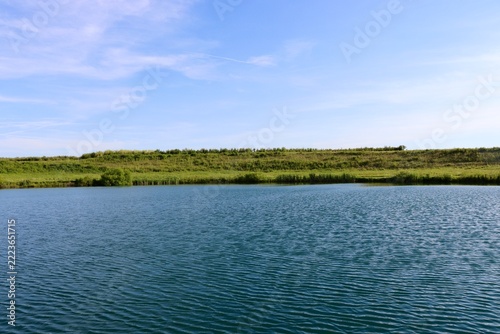 The peaceful lake in the country on a sunny day.