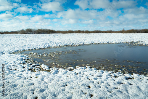 Water freezing in a snow-covered field