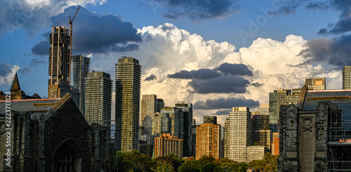 Photography Toronto downtown city skyline with old church and skyscrapers, dramatic cloud sk