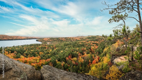 An elevated, panoramic view from a cliff looking over the forests and lakes of Algonquin Provincial Park during autumn in Ontario, Canada