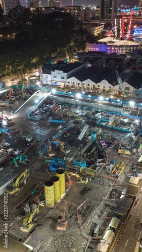 night illumination singapore city center working construction yard aerial vertical panorama 4k timelapse