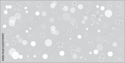 Abstract festive background with soft white bokeh circles and sparkling star shapes on a light grey backdrop.