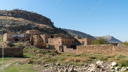 Dereici, the abandoned Syriac village also known as Killit, near Savur in Mardin, Turkey, with stone houses below a rocky hillside
