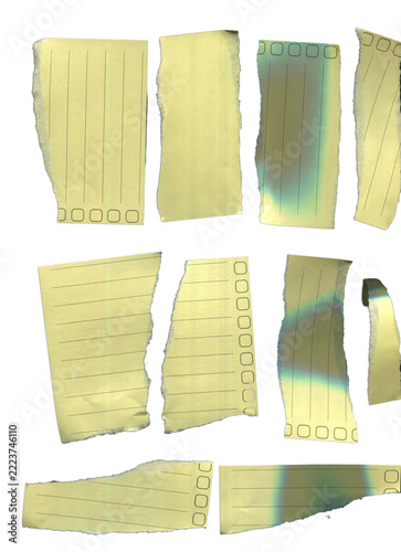 Torn pieces of yellow lined notepad paper with checkboxes isolated on white background