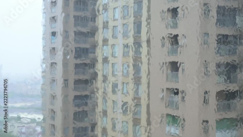Residential high rise buildings viewed through rain covered window glass video with sound