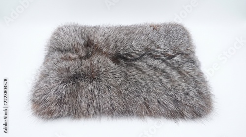 close-up of a grey fox fur textile swatch showing dense silver and charcoal fibers on white